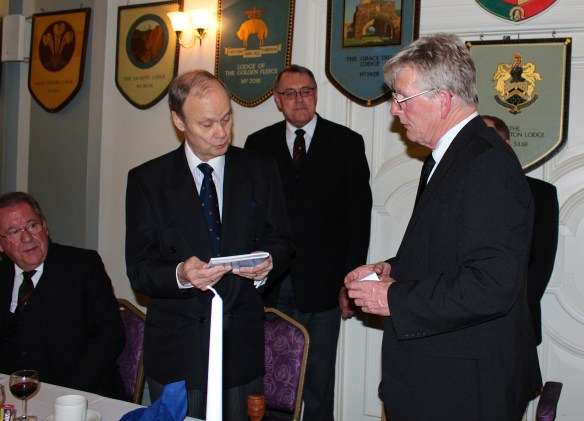 The Assistant Grand Master being presented with the Lodge history