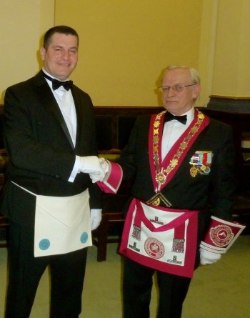 Bro. Chris Panteli (left) being congratulated by the Master of the Derek Buswell Lodge of Provincial Grand Stewards